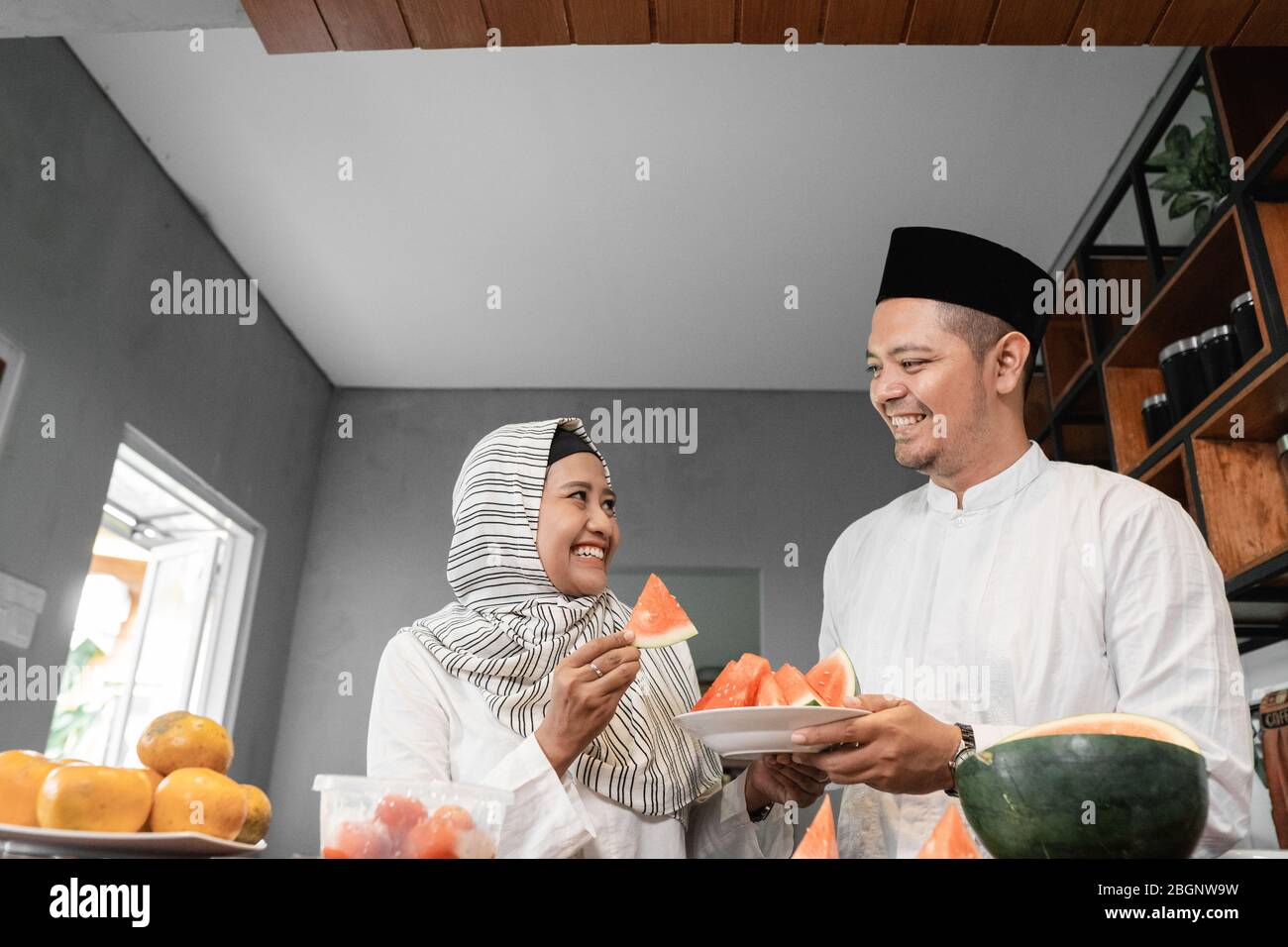 man and muslim woman having some fruit for break fasting dinner Stock Photo Alamy