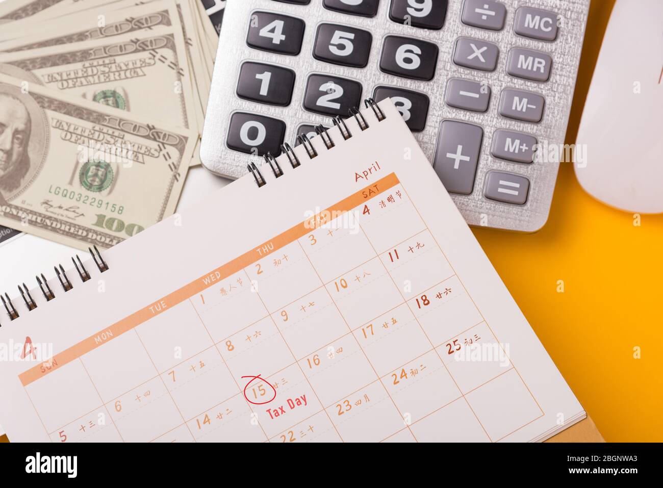 April of the year is Tax Day, Top view flat lay closeup calculator, laptop  computer, calendar, and Dollar money, on yellow background business finance  Stock Photo - Alamy