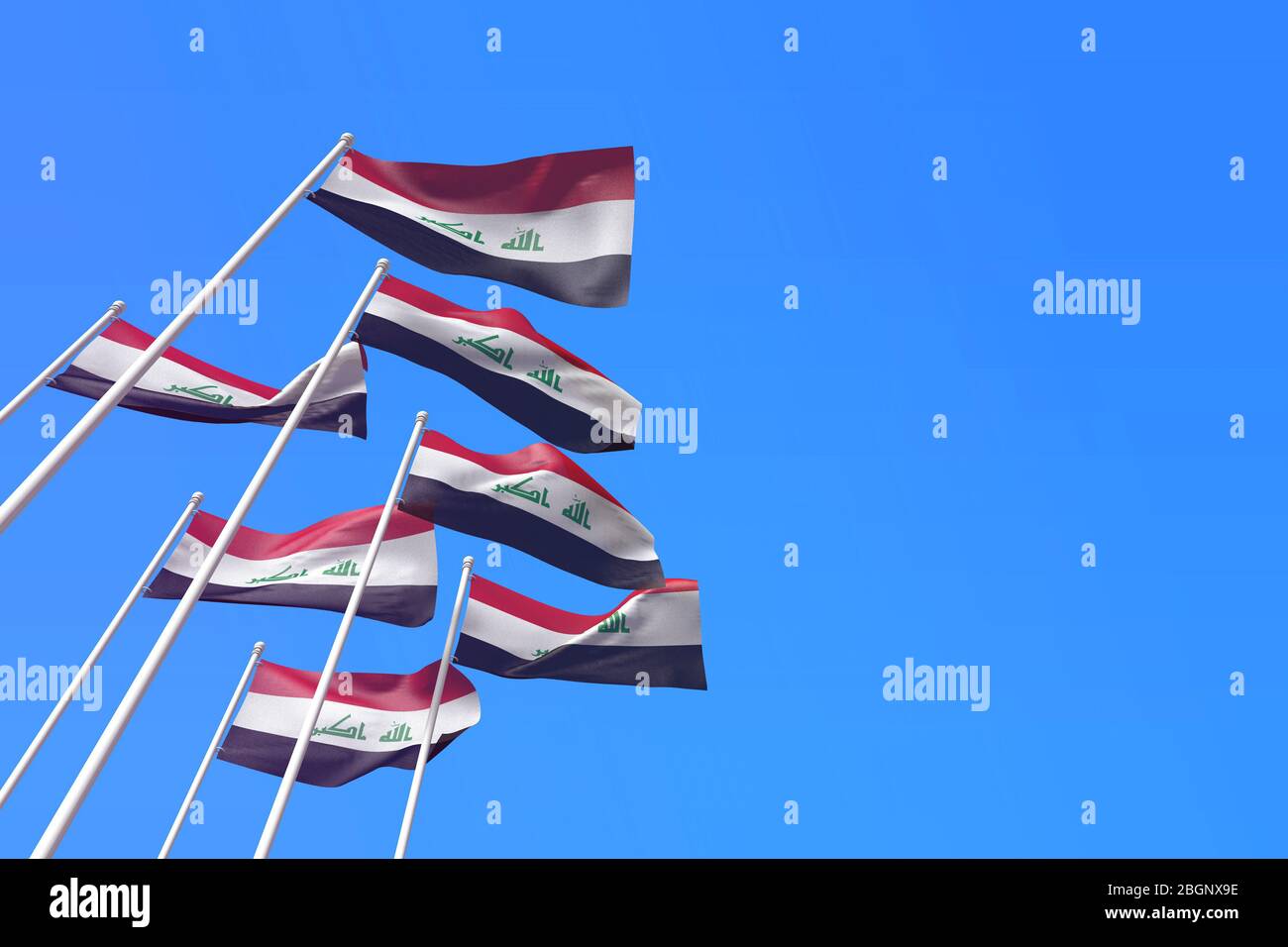 Iraq flags waving in the wind against a blue sky. 3D Rendering Stock Photo