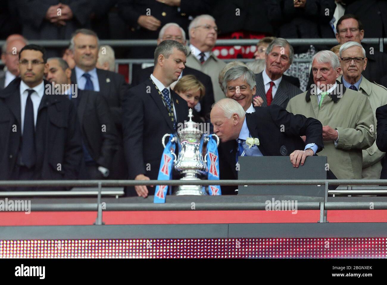 LONDON, ENGLANDWigan Chairman Dave Whelan kisses the FA Cup after Wigan's victory in The FA Cup With Budweiser Final match between Manchester City & Wigan Athletic at Wembley Stadium in London on Saturday May 11th 2013. (Credit: MI News) Stock Photo