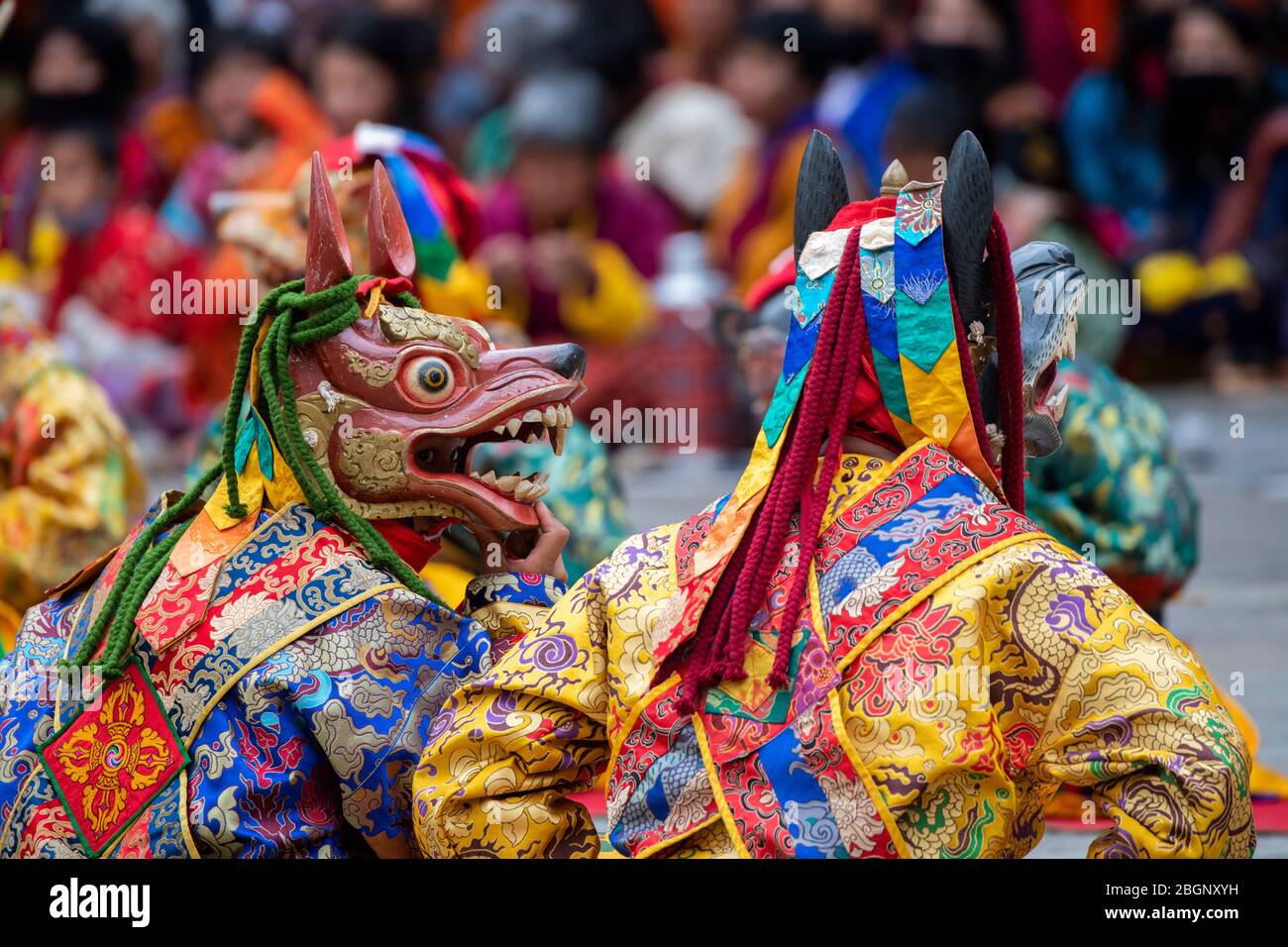 Bhutan, Punakha Dzong. Punakha Drubchen Festival, masked performers in colorful attire. Stock Photo