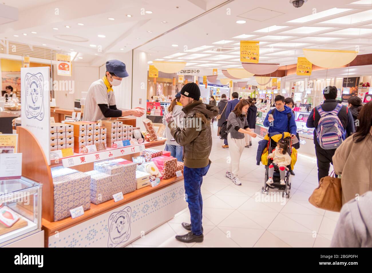 A Japanese man is buying some sweet from sweet shop in Tokyo Skytree