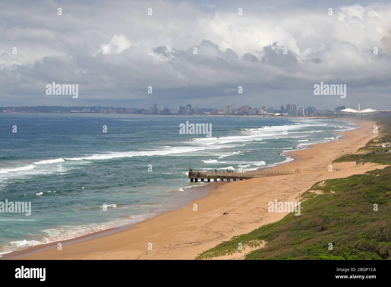 Aerial photo of coastline and pier looking towards Durban CBD and Moses Mabhida Stadium Stock Photo