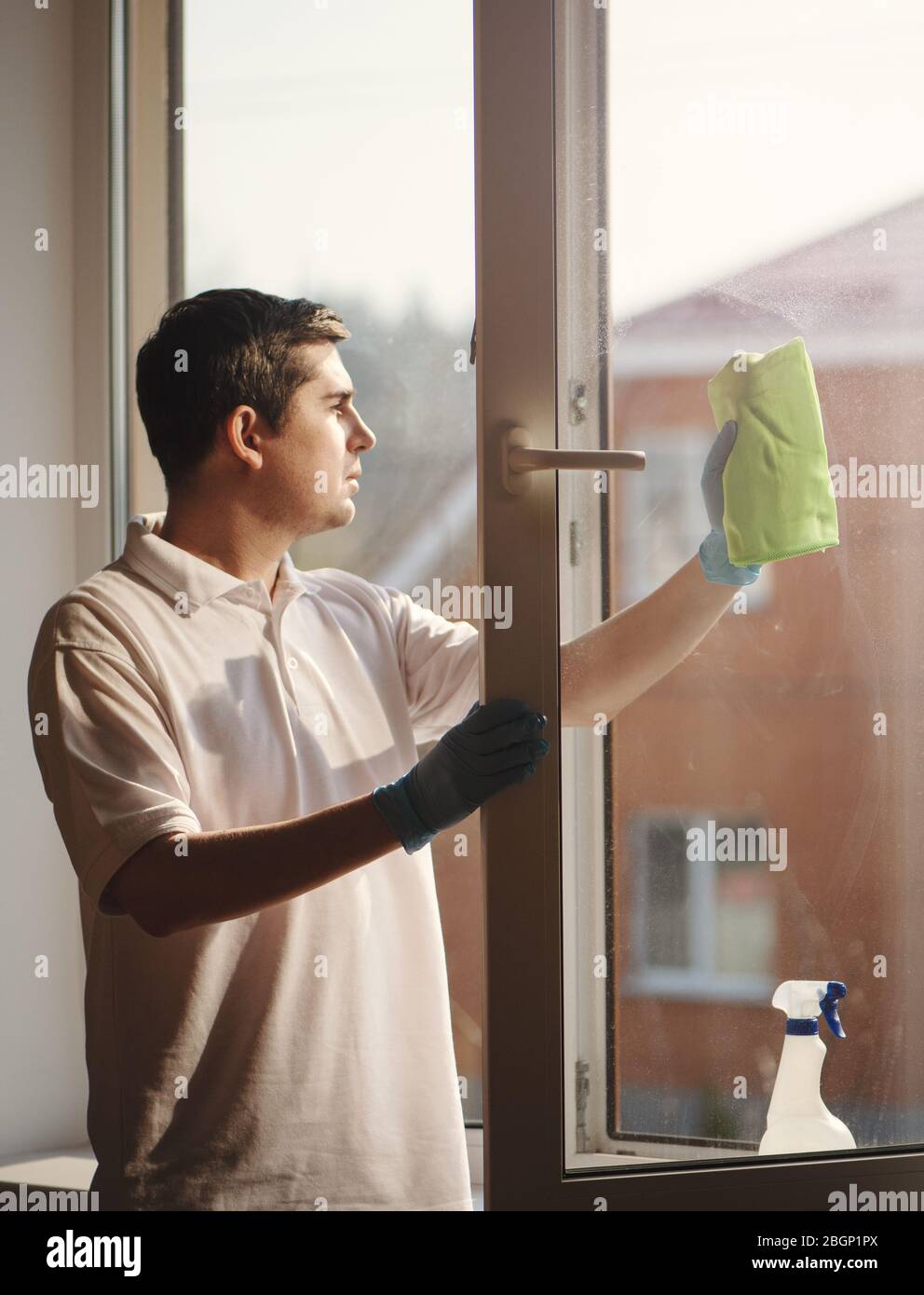 Premium Photo  Man washing and cleaning window at home housework
