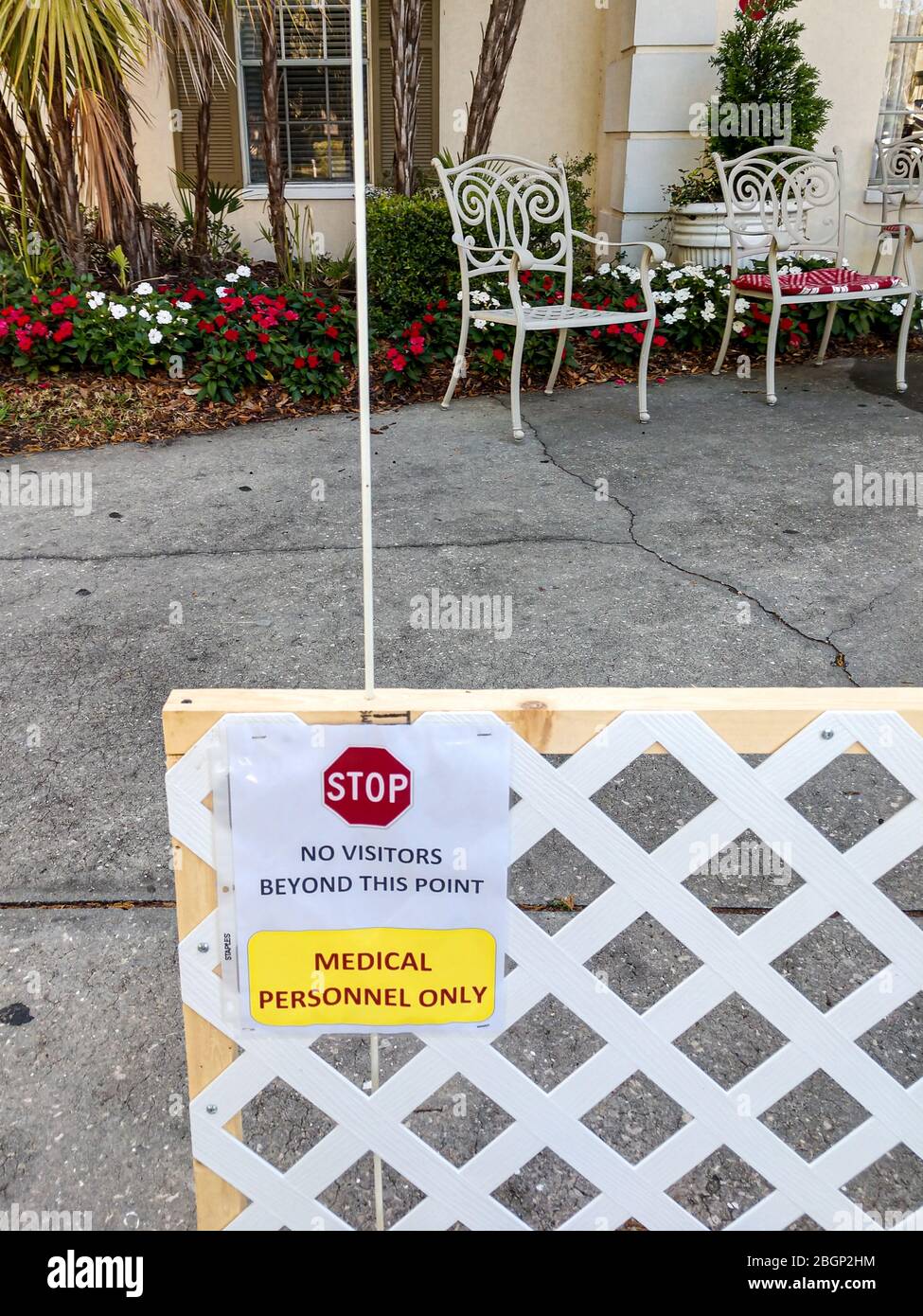 Signs and fencing exhibiting new rules to protect residents at assisted living facility during pandemic. Stock Photo