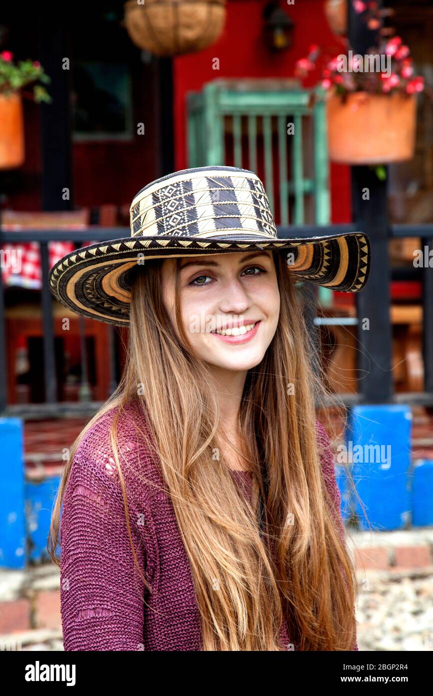 Young pretty girl wearing a sombrero vueltiao,(Colombian Spanish for turned hat)  a traditional Colombian hat, outside a traditional Colombian 'finca' Stock Photo