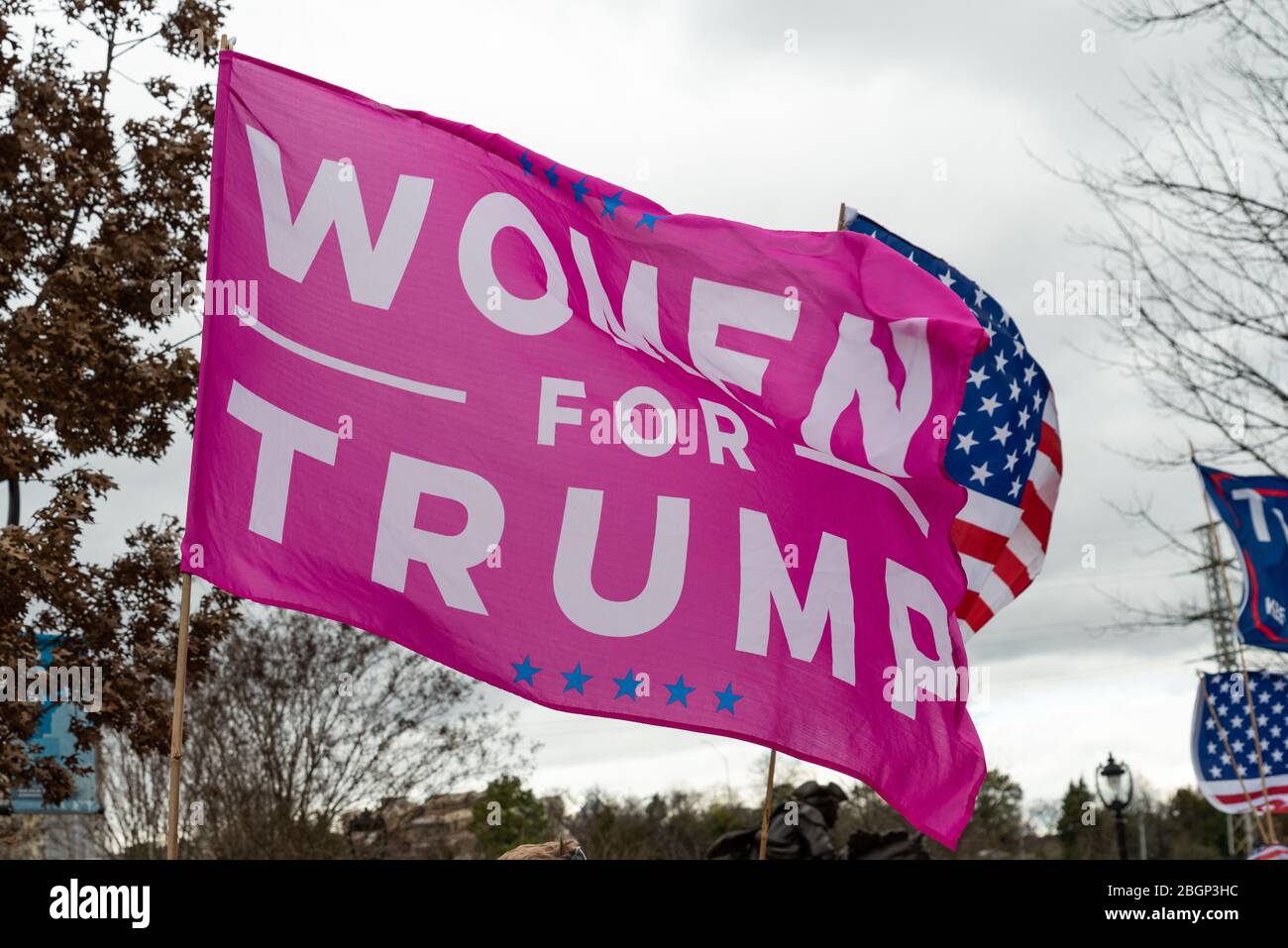 CHARLOTTE, NORTH CAROLINA/USA - February 7, 2020: Women for Trump flag flies in the wind awaiting President Donald Trump's visit to Charlotte, NC Stock Photo