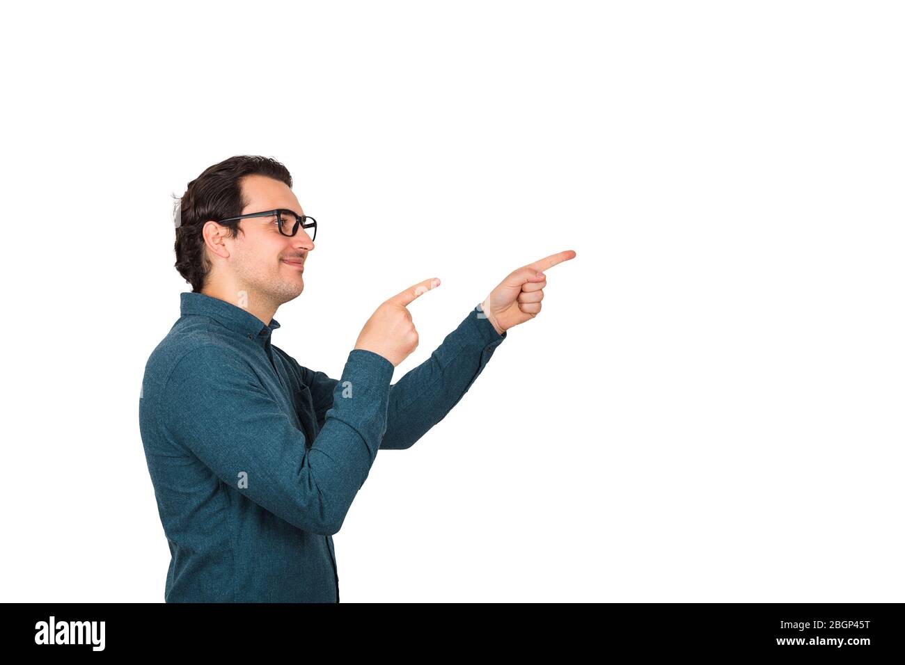 Side view portrait of carefree and friendly businessman, wears glasses smiling broadly, pointing fingers pay attention to someone, greeting friend ges Stock Photo