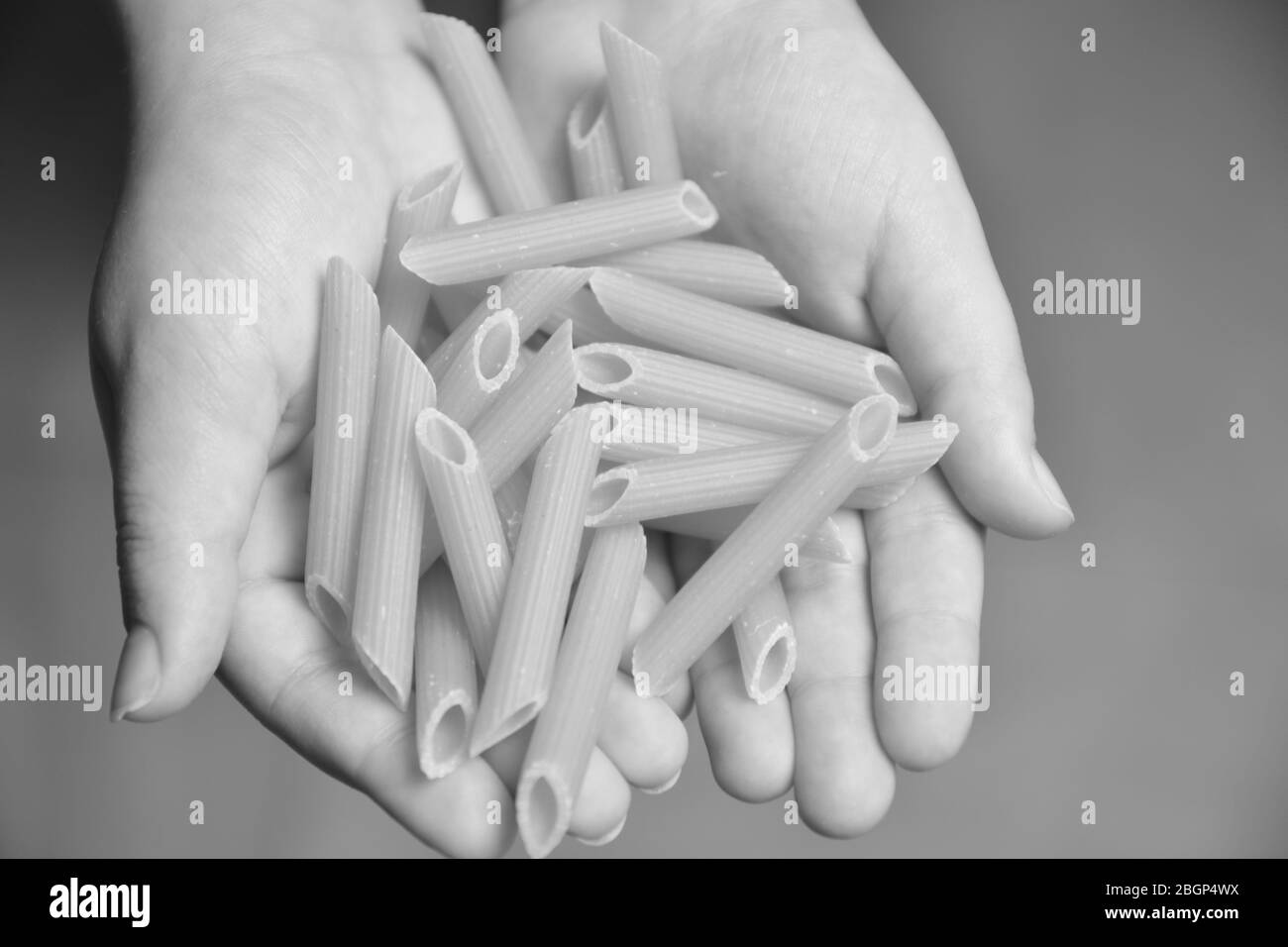italian pasta in the hand Stock Photo Alamy