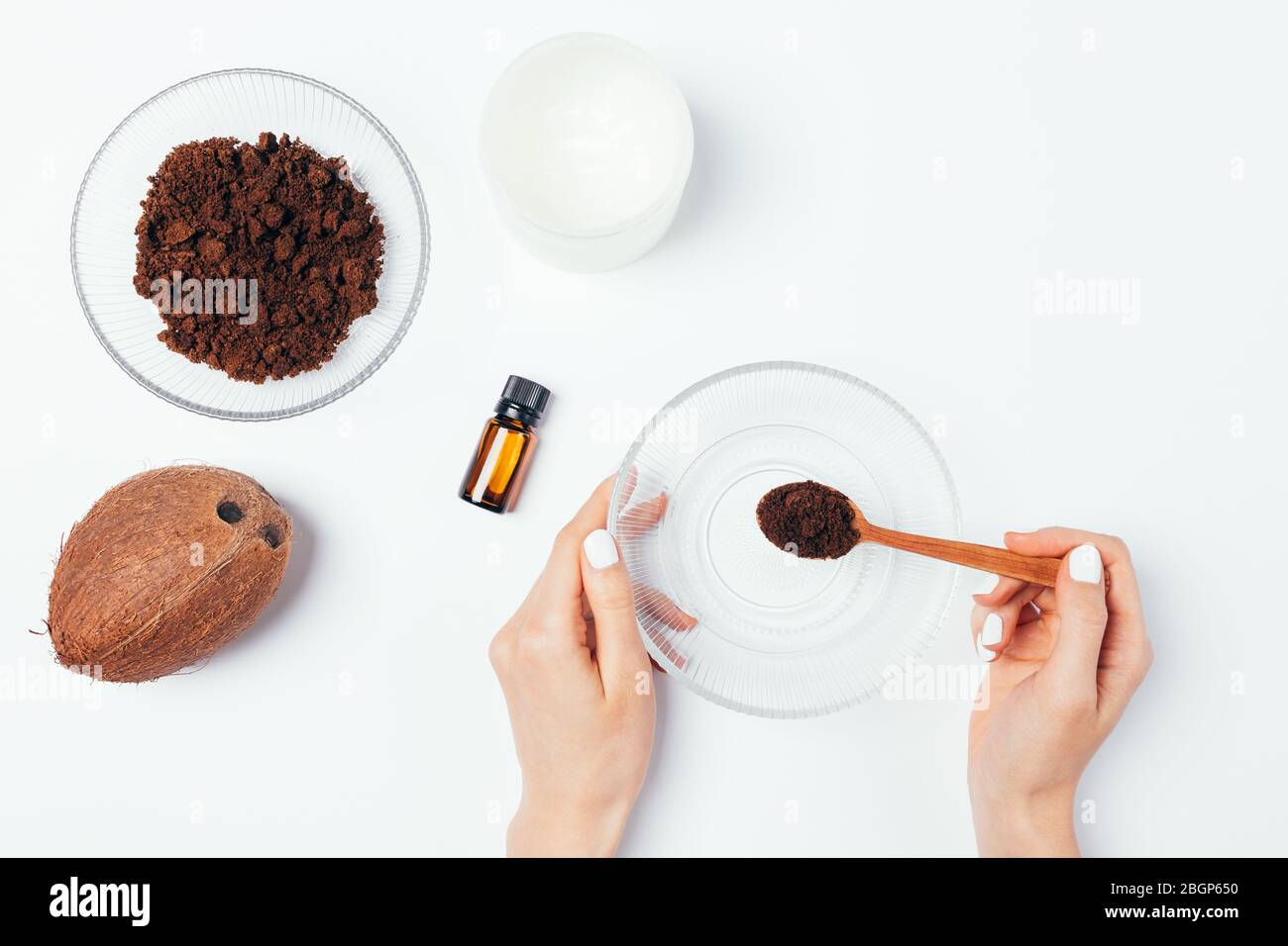 Young Woman Prepares Homemade Natural Body Scrub Made Of Ground Coffee Coconut Oil And Aromatic Essence View From Above On White Table Stock Photo Alamy