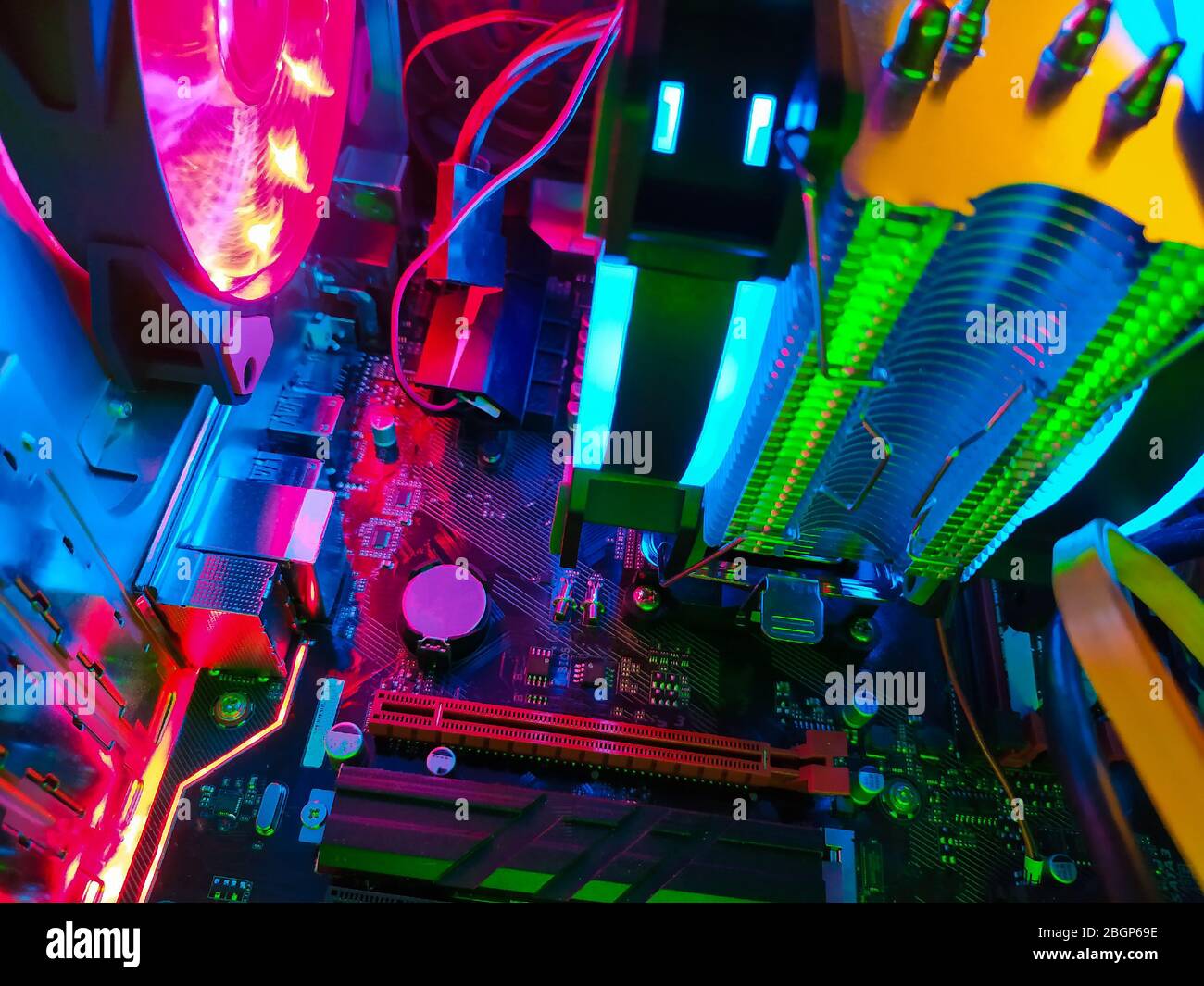 Modern computer air cooling with multi-colored led backlight-fans, cooling radiators, cables, boards, close-up, macro. Stock Photo