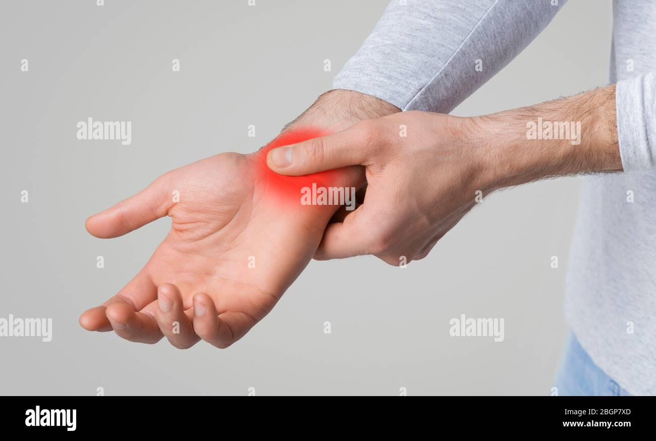 Wrist pain concept. Sore spot highlighted in red Stock Photo Alamy