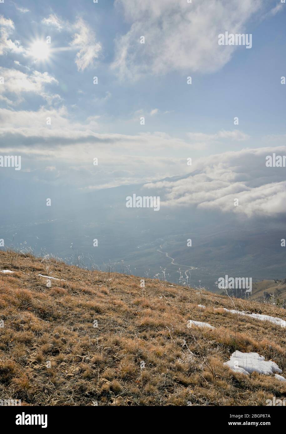 Dry grass. Mountain valley in the background. Vertical layout for local travel stories Stock Photo
