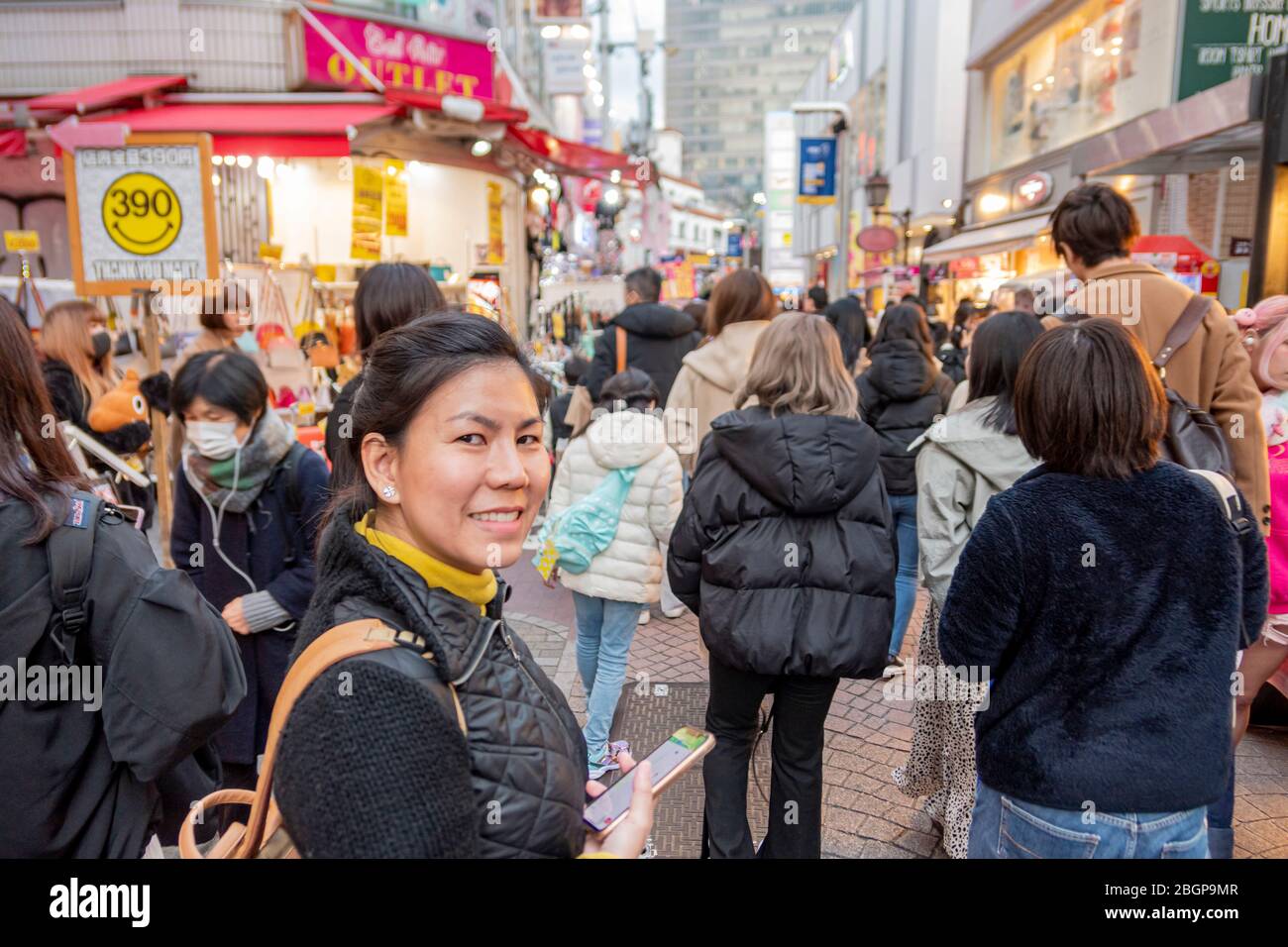 A tourist woman is smiling happily while walking in Shinjuku alley where is the best place for shopping in Tokyo, Japan February 8,2020 Stock Photo