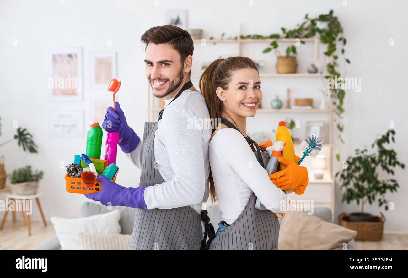 Husband and wife with cleaning supplies at home Stock Photo Alamy