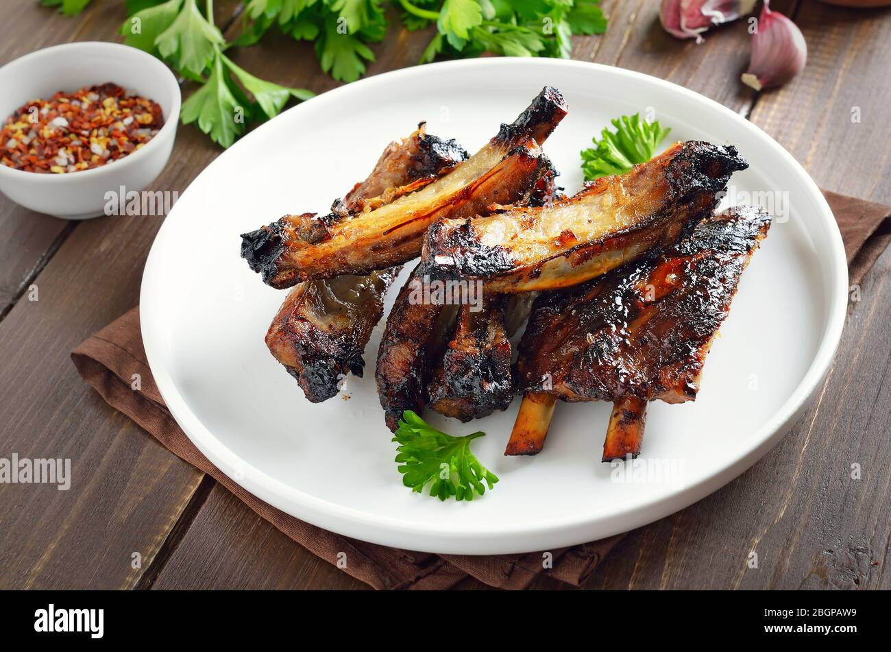 Grilled pork ribs on white plate. Tasty bbq meat Stock Photo