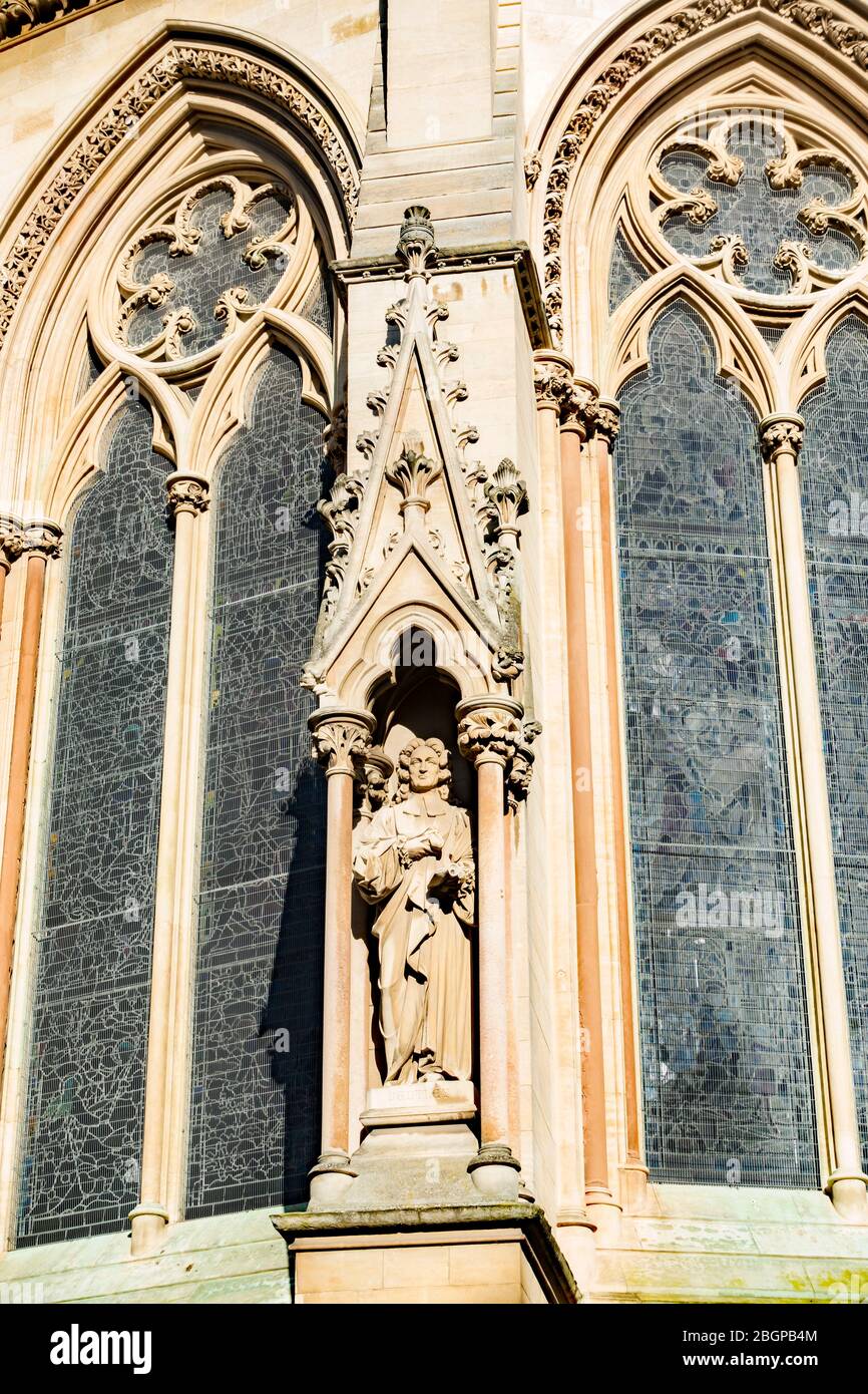 Carved statue on plinth in ornate recess St John's Chapel Cambridge February 2020 Stock Photo