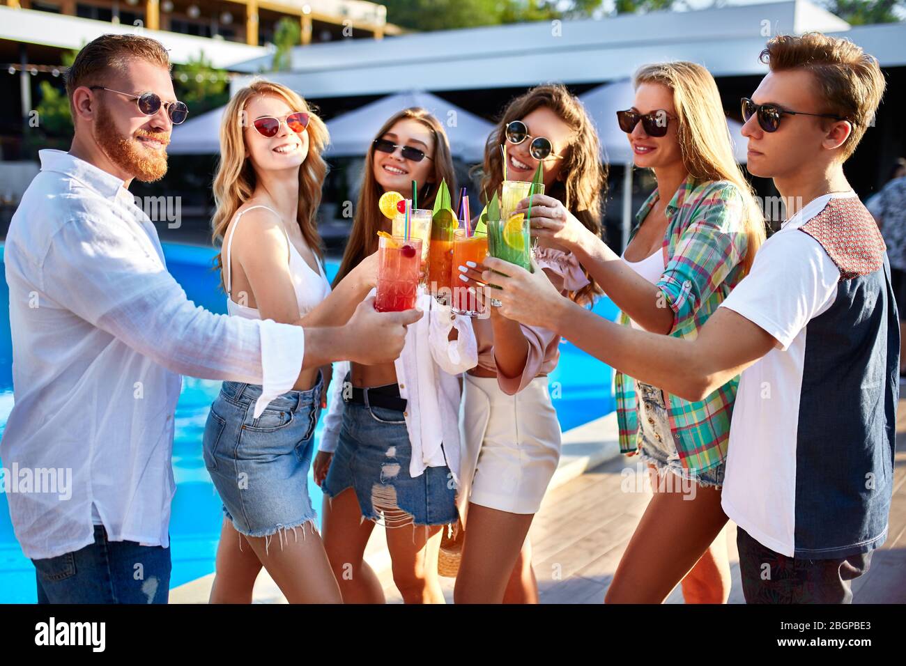 Group Of Friends Having Fun At Poolside Summer Party Clinking Glasses With Colorful Summer Cocktails Outdoors Near Hotel Swimming Pool People Toast Stock Photo Alamy