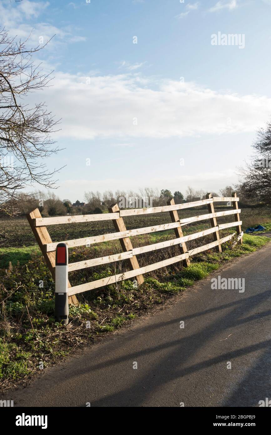 Leaning fence Fen Road Milton Cambridgeshire Stock Photo