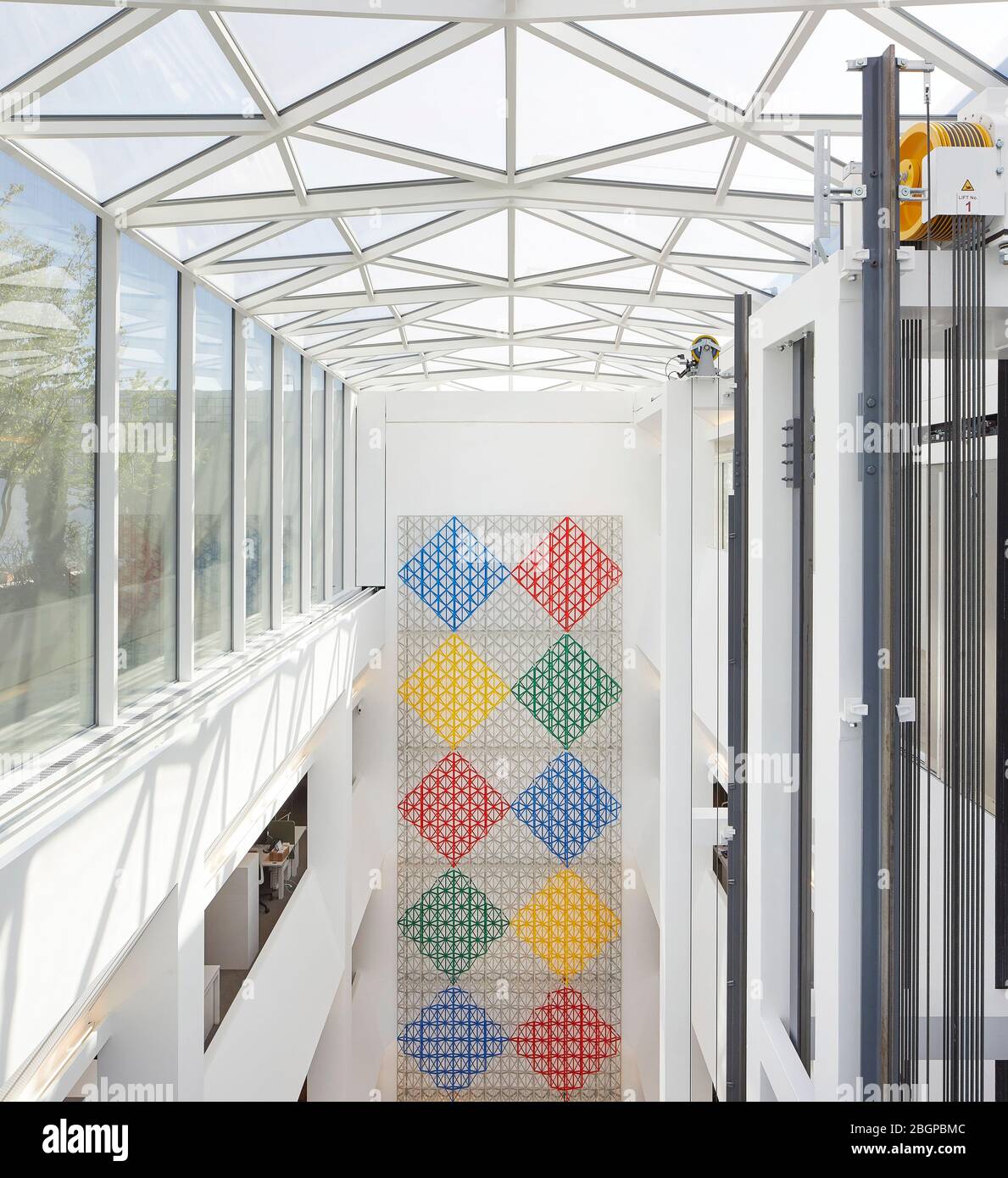Atrium with artwork by Rasheed Araeen, named Rhapsody in Four Colours. Aga Khan Centre Kings Cross, London, United Kingdom. Architect: Maki and Associ Stock Photo
