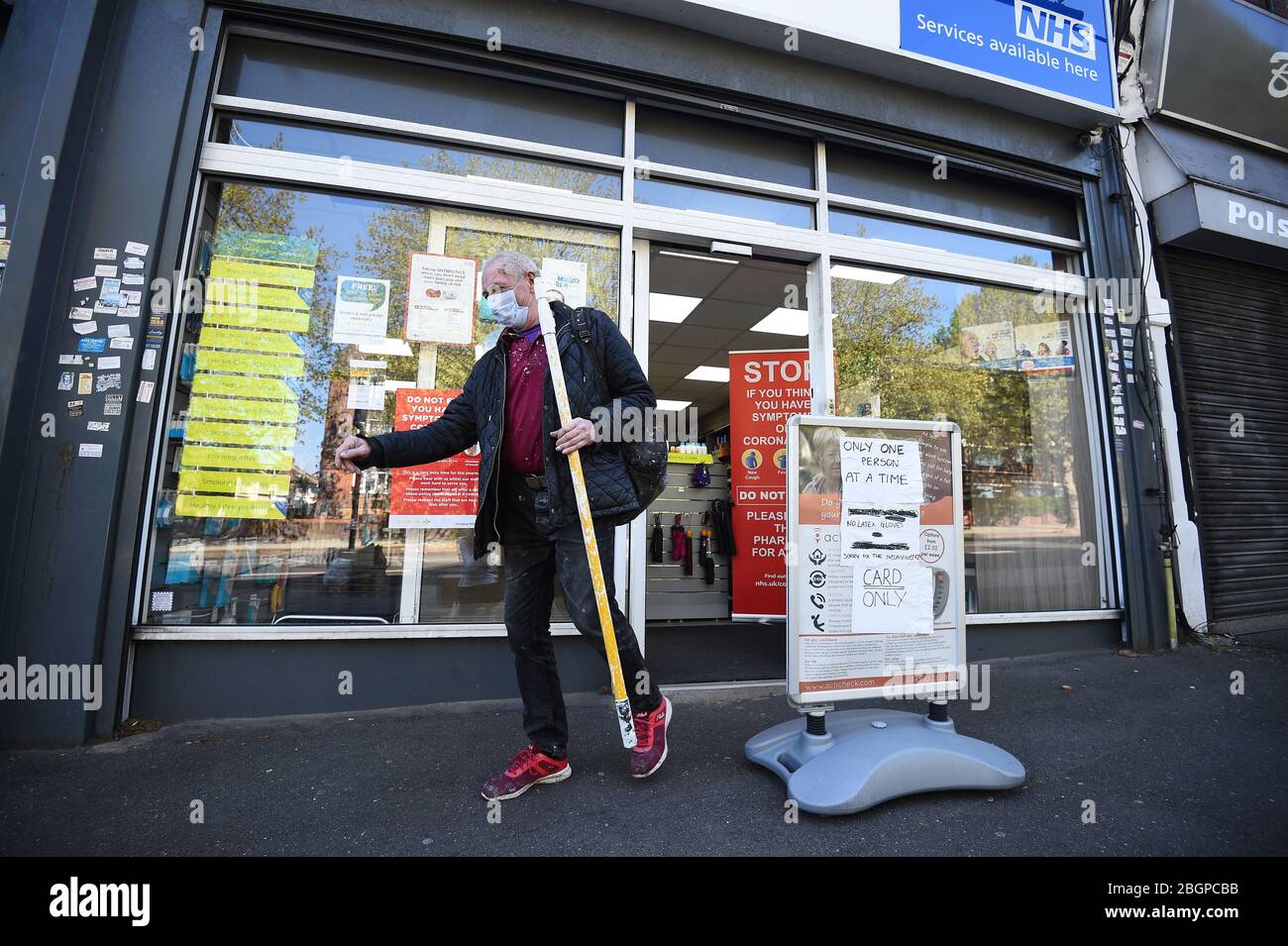 A customer exits Copes Pharmacy in Streatham, as the UK continues in lockdown to help curb the spread of the coronavirus. Stock Photo