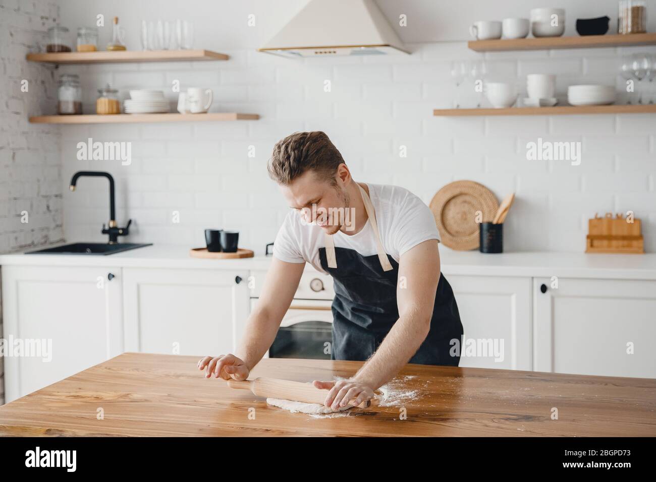 Chef hands rolling pizza dough on light kitchen background Stock Photo