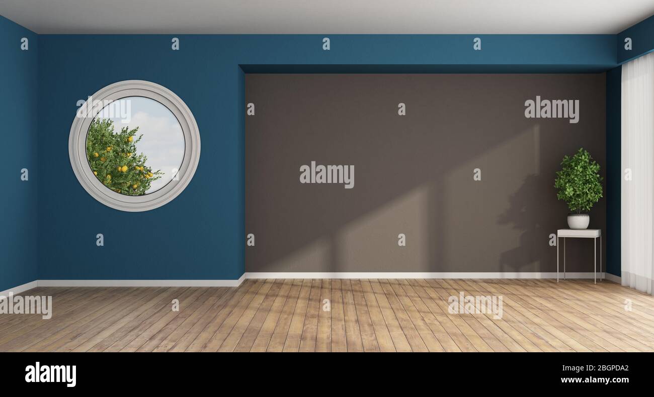 Empty living room with round window on blue wall and houseplant - 3d rendering Stock Photo
