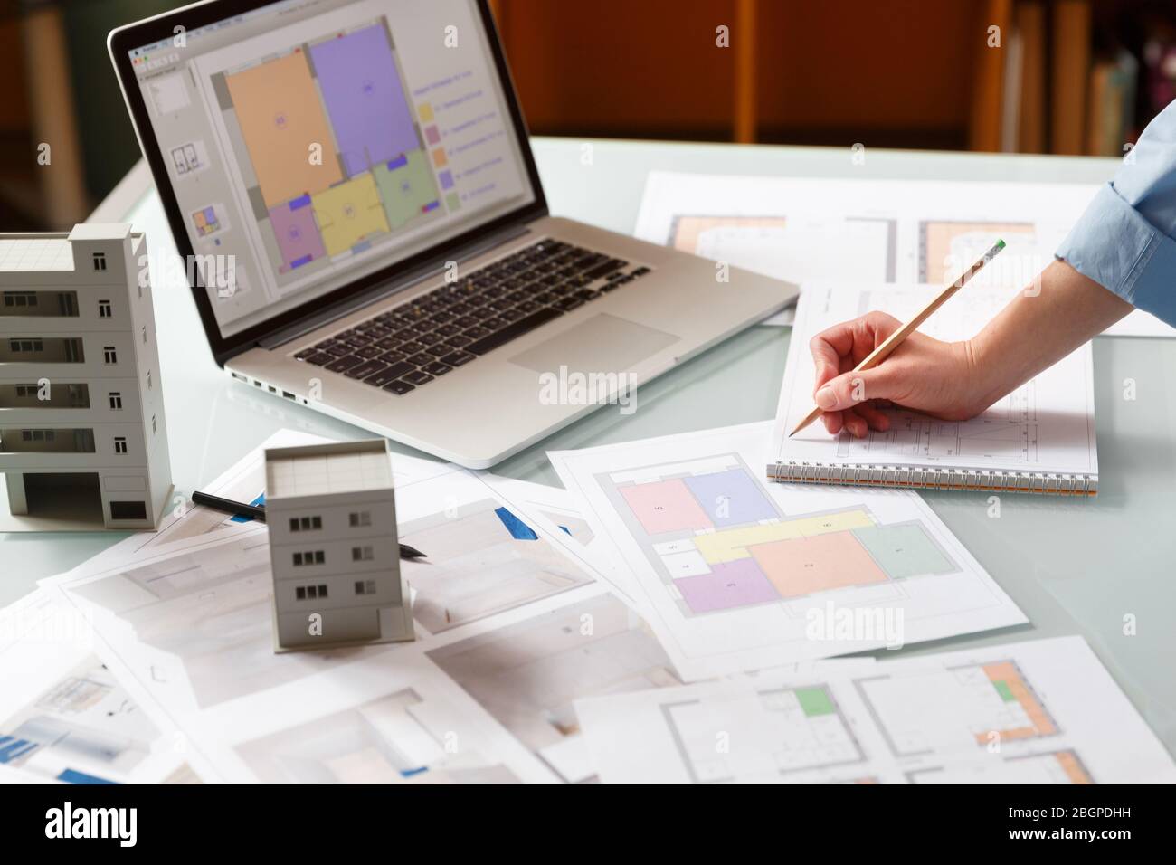 Interior designer working with an apartment plans in a studio, with ...