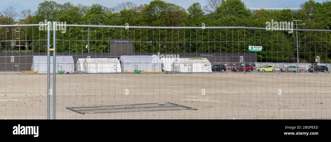 Panorama with white tents of the Coronavirus (Covid-19) Test Station at Theresienwiese. With cars waiting in line. Behind a fence. Stock Photo