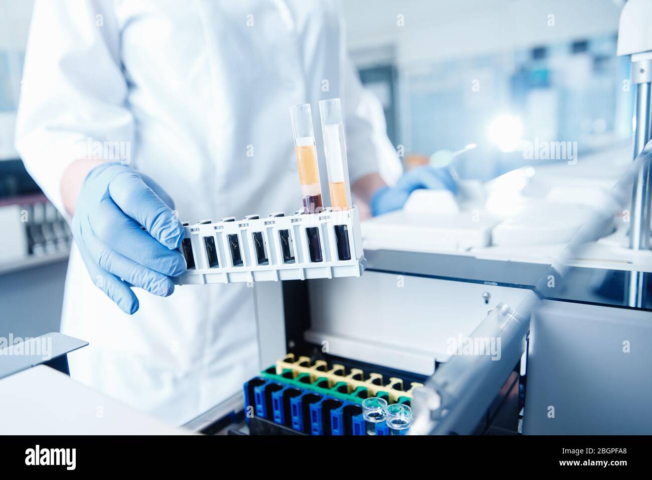 Biomedical Testing Medical equipment bioengineer installs blood test on tubes in automatic ...