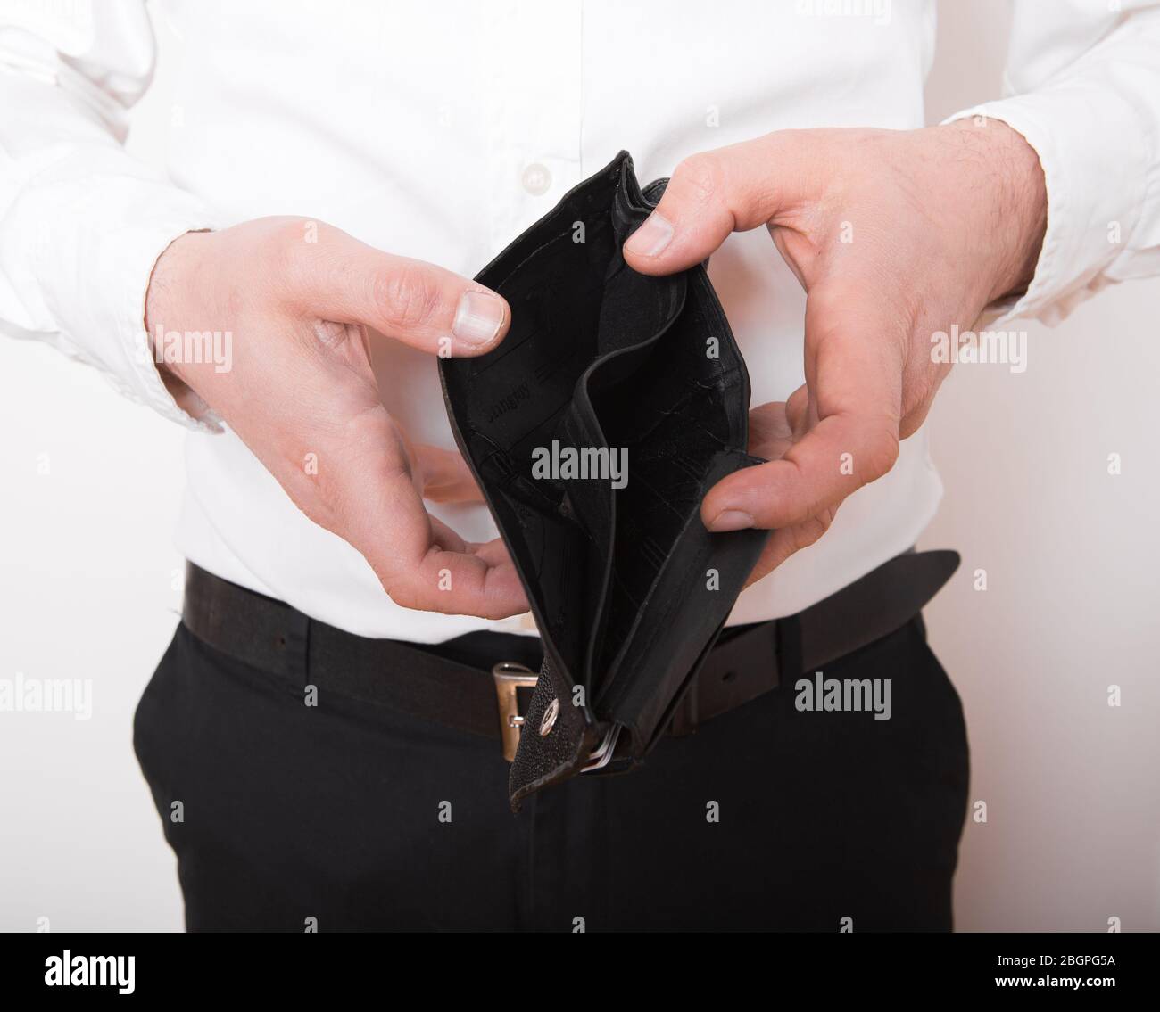 Bankruptcy - Business Person holding an empty wallet. Man showing  the inconsistency and lack of money and not able to pay the loan and the mortgage. Stock Photo