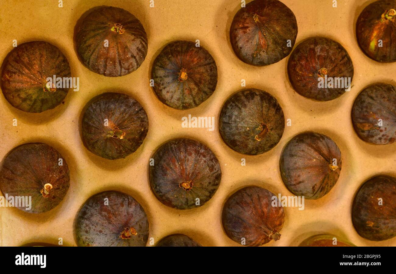 Top view of fresh fig fruits on an organic packaging for sale at market