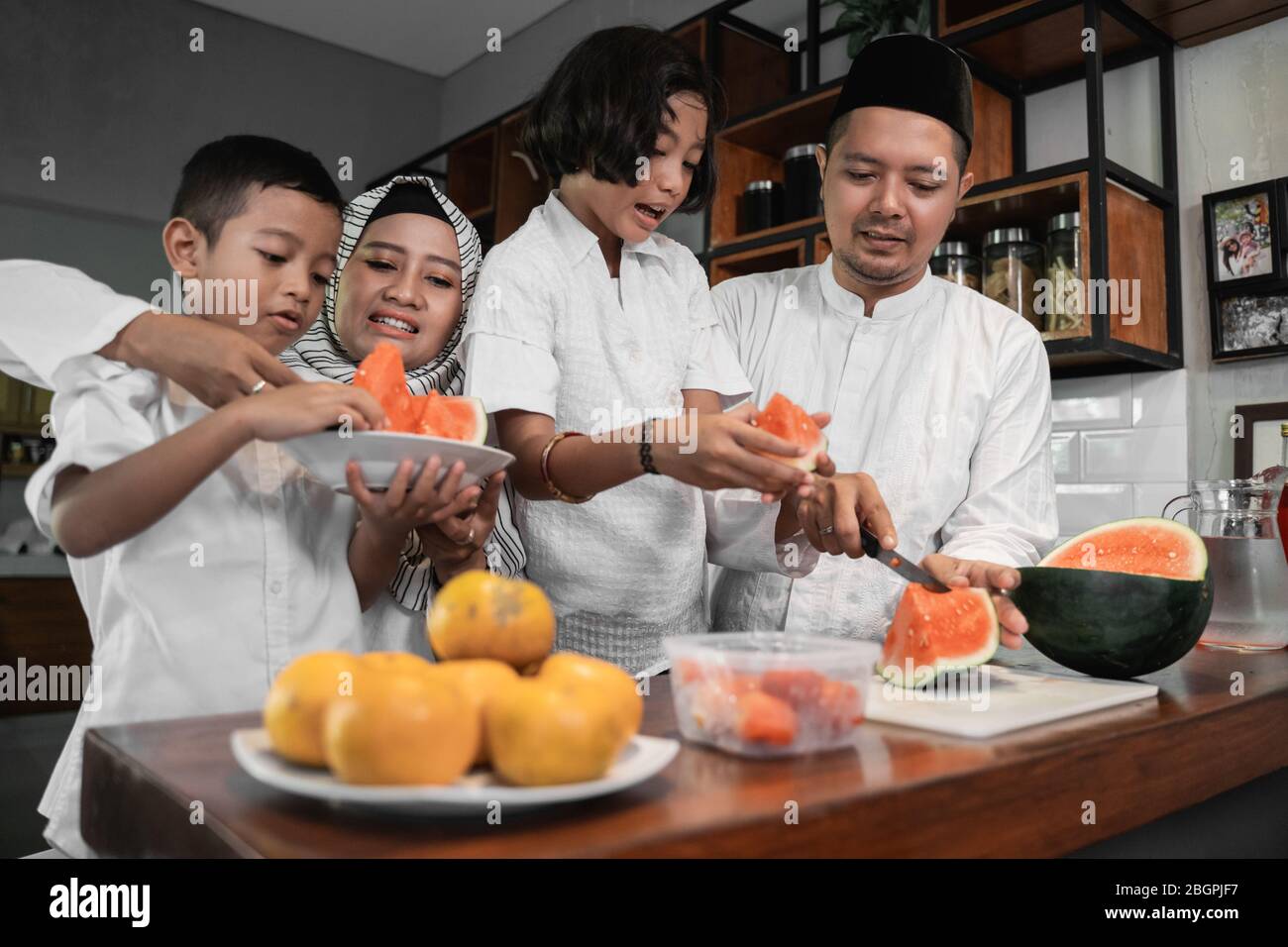 muslim asian family and kids preparing for fasting break on ramadan Stock Photo