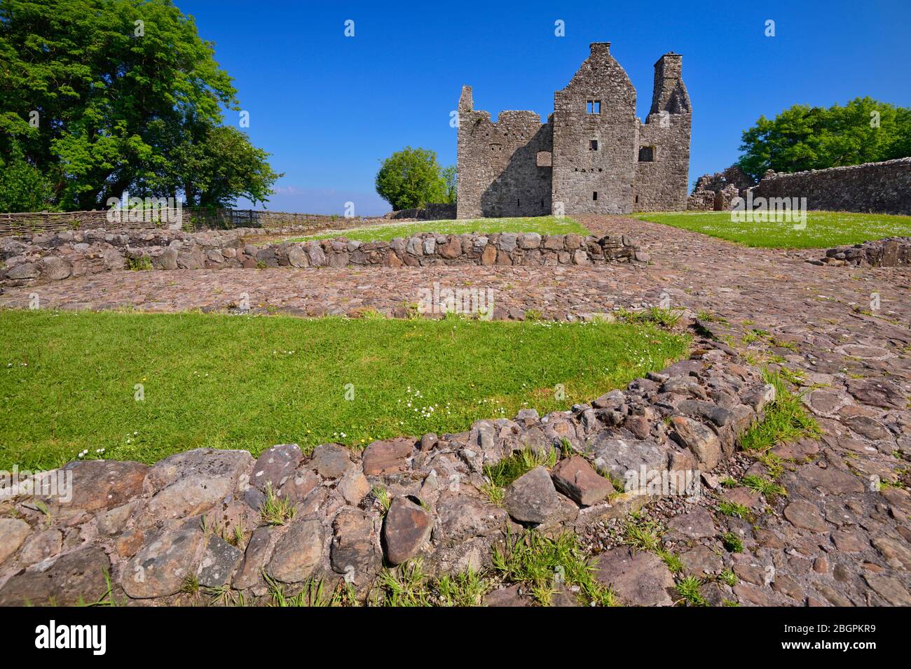 Ireland, County Fermanagh,  Ruin of Tully Castle on the shores of Lough Erne which was a fortified house with a rectangular bawn built for Sir John Hume, a Scottish planter, in 1619. Stock Photo