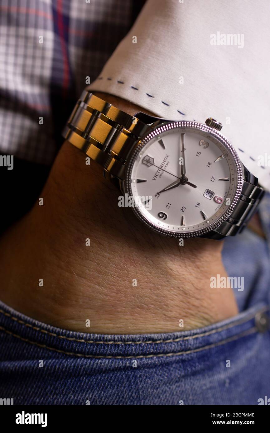 Ibach, Switzerland 31.03.2020 - Closeup fashion image of Victorinox watch  on wrist of man: man's hand in blue jeans pocket with white cuff of plaid  Stock Photo - Alamy