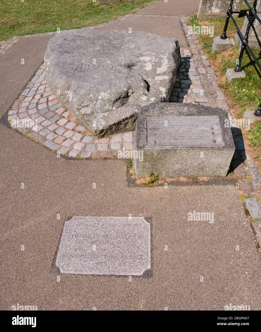 Ireland, County Down, Downpatrick, Mourne granite slab marking the traditional burial place of St Patrick at the Cathedral Church of the Holy Trinity also known as Down Cathedral. Stock Photo