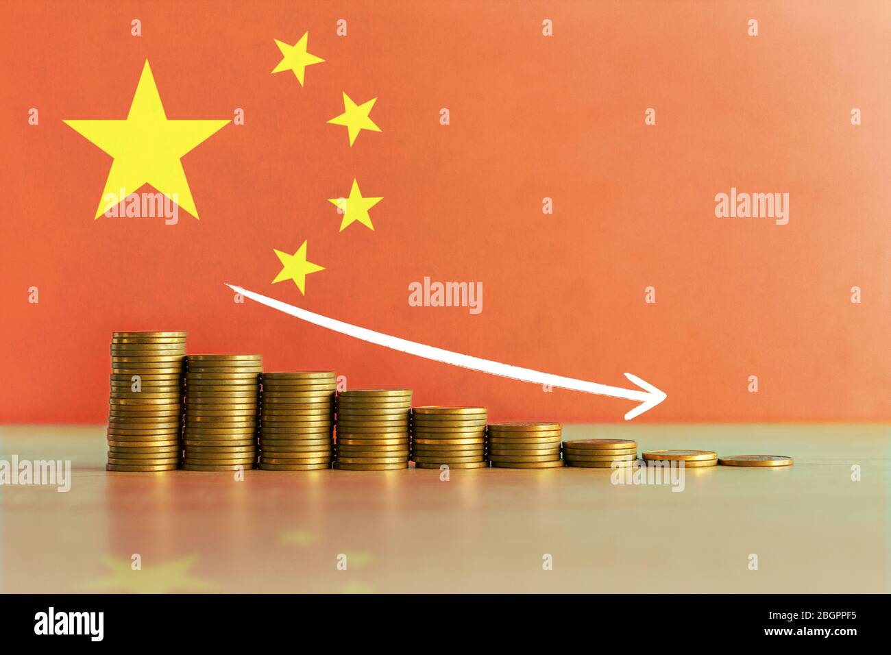 Stock photo of economic crisis and recession concept in China with descending ladder of coins and flag in background Stock Photo