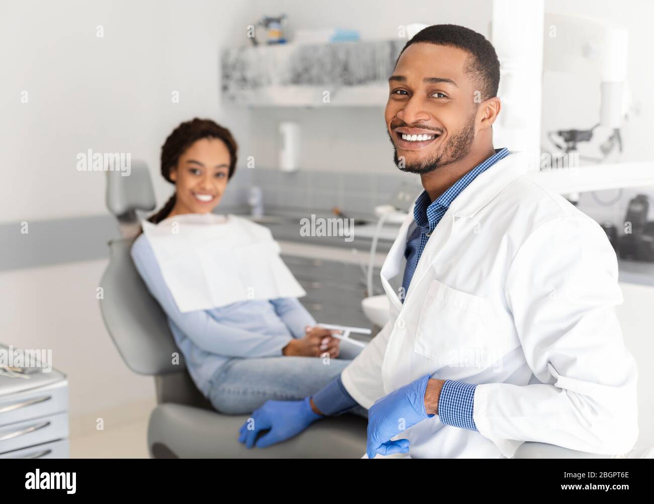 Black dentist doctor and patient in chair smiling at camera Stock Photo Alamy