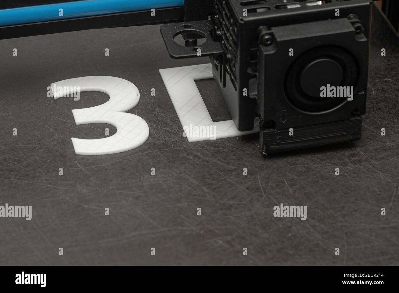 3D printer prints the word 3D with white filament PLA Stock Photo
