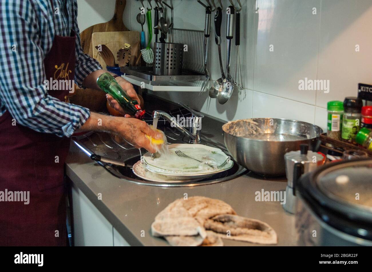 Adult man washing dirty dishes Stock Photo