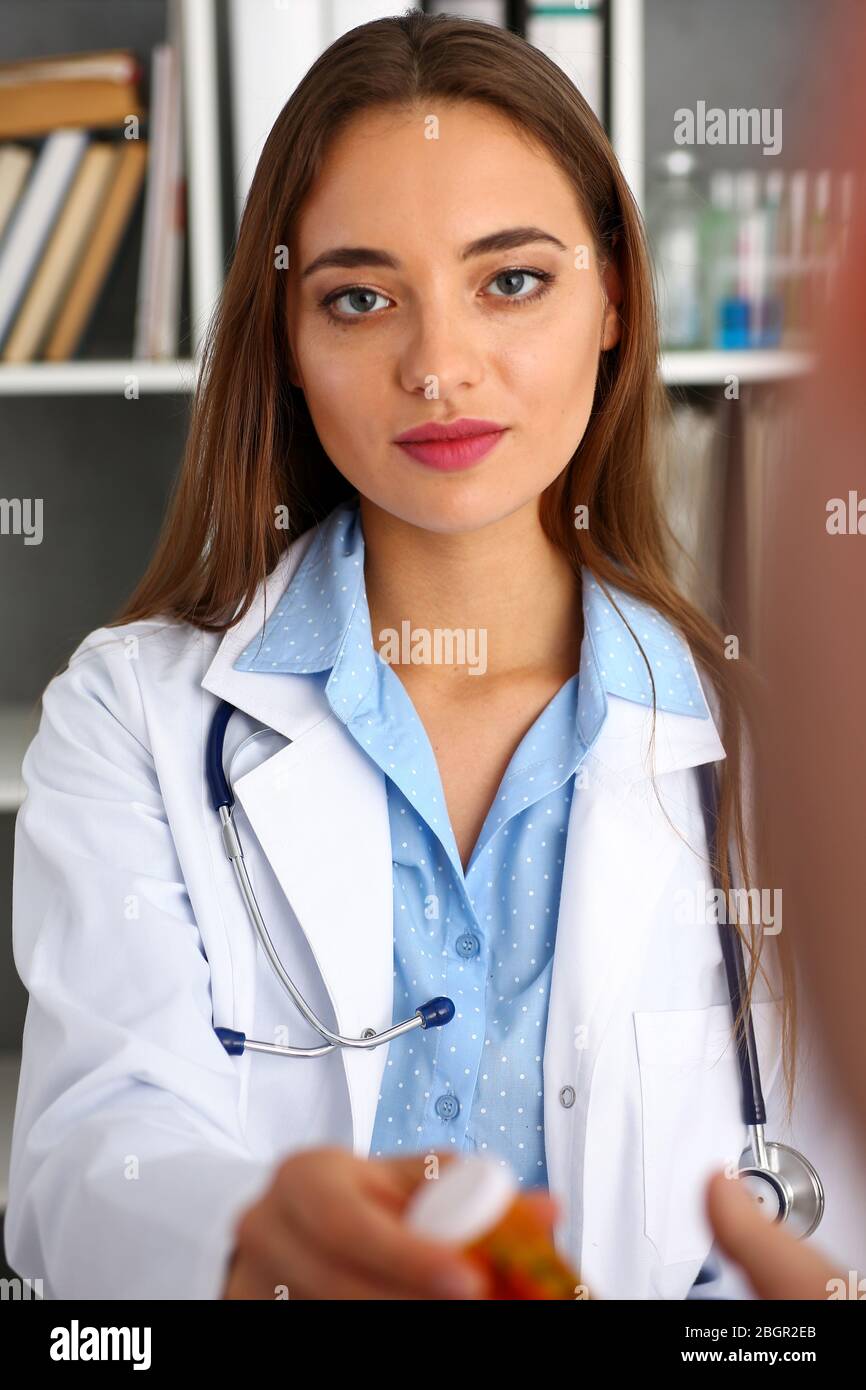 Beautiful female doctor hold in arms pill bottle Stock Photo Alamy