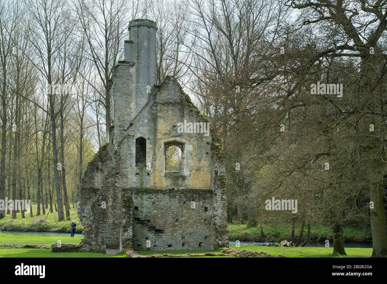 Tourist photographing ancient ruin of the house and dovecote of Minster Lovell Hall, a 15th century manor house in The Cotswolds, Oxfordshire, UK Stock Photo