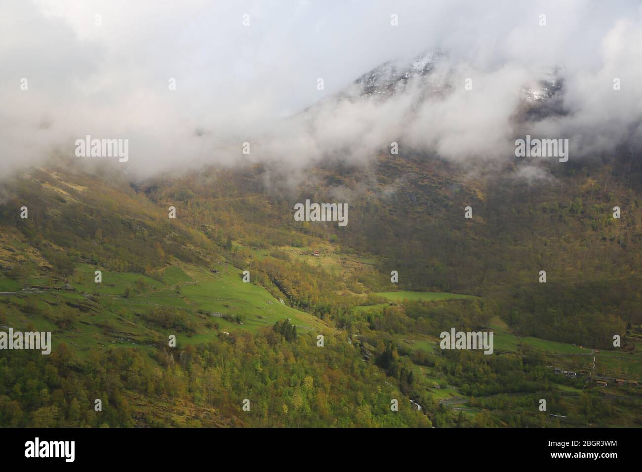 Mist over the mountains in Geirangerfjord Stock Photo