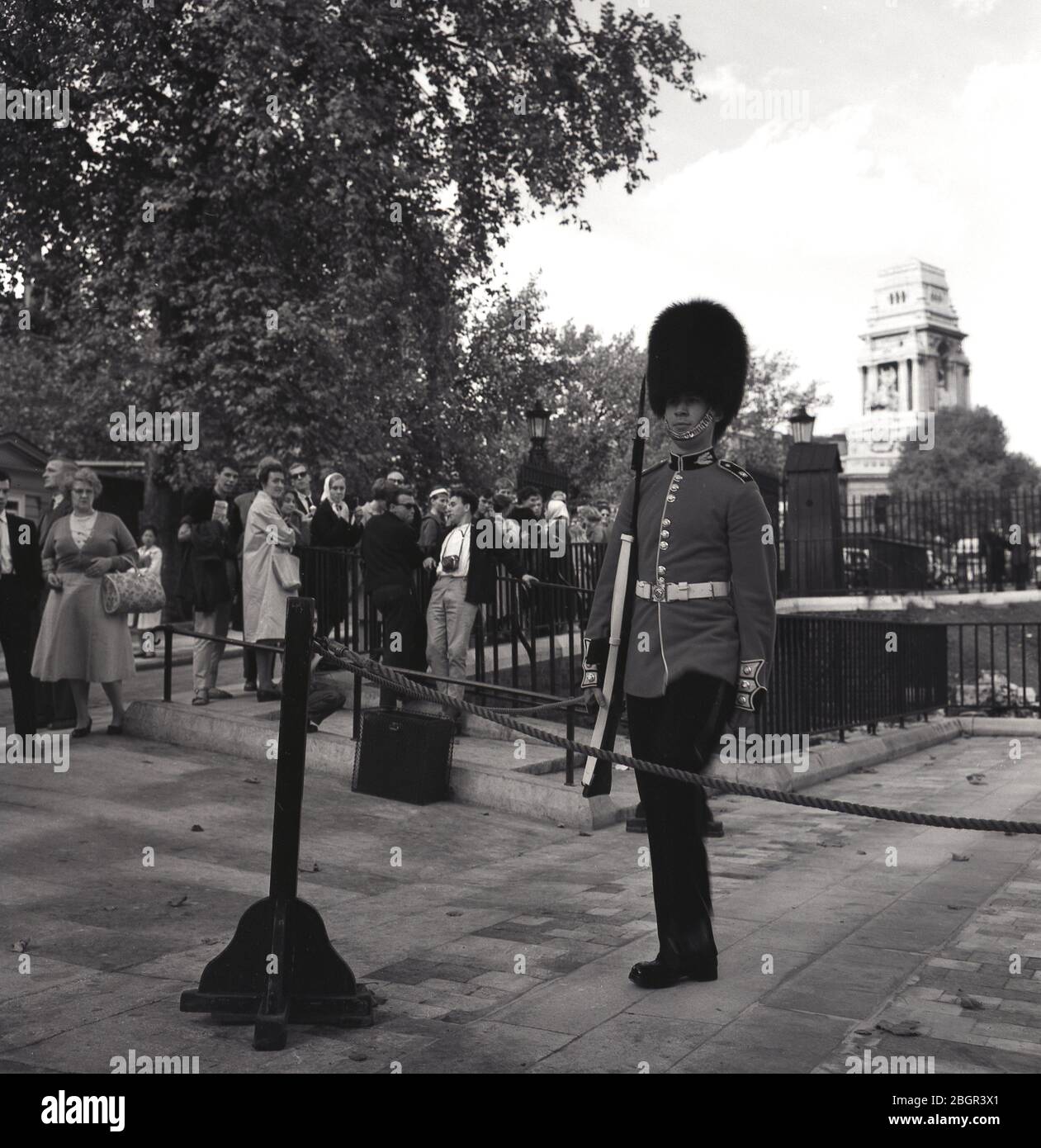 1960s, historical, St James Palace, London, England, UK, spectators watching a Queens Guard of the British Army's Household Division performing ceremonial duties. Stock Photo