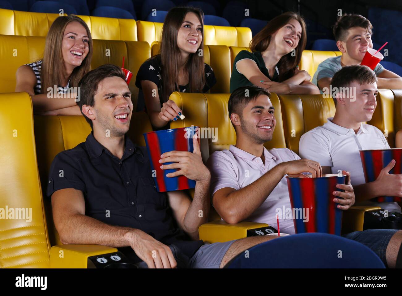 Young people watching movie in cinema Stock Photo - Alamy