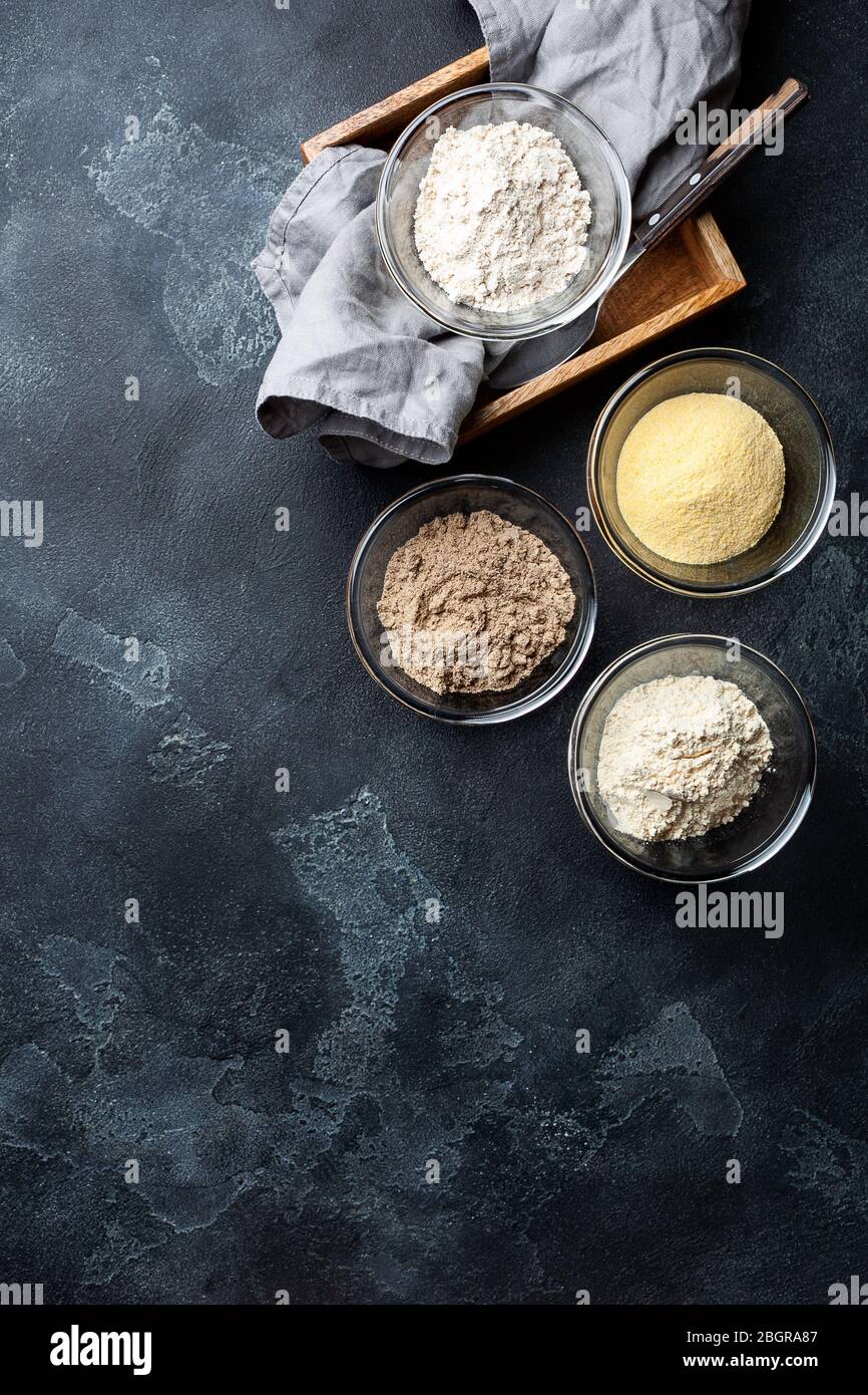 Various vegetable gluten free flour corn,sesame,oat,coconut in glass bowl on dark gray