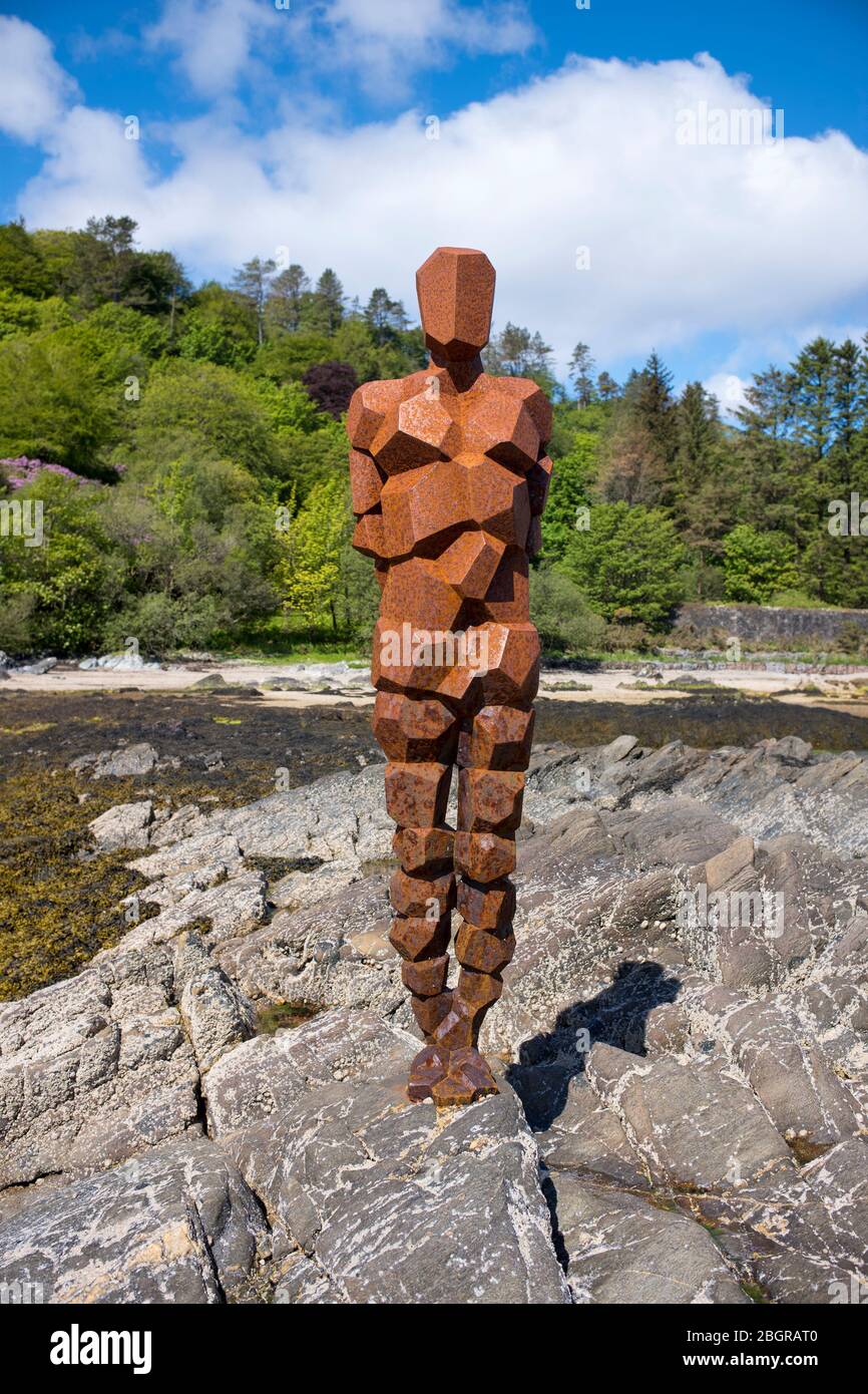 Antony Gormley sculpture GRIP of an abstract human form looking out over Saddell Bay, Kilbrannan Sound to Arran, in Kintyre, Scotland Stock Photo