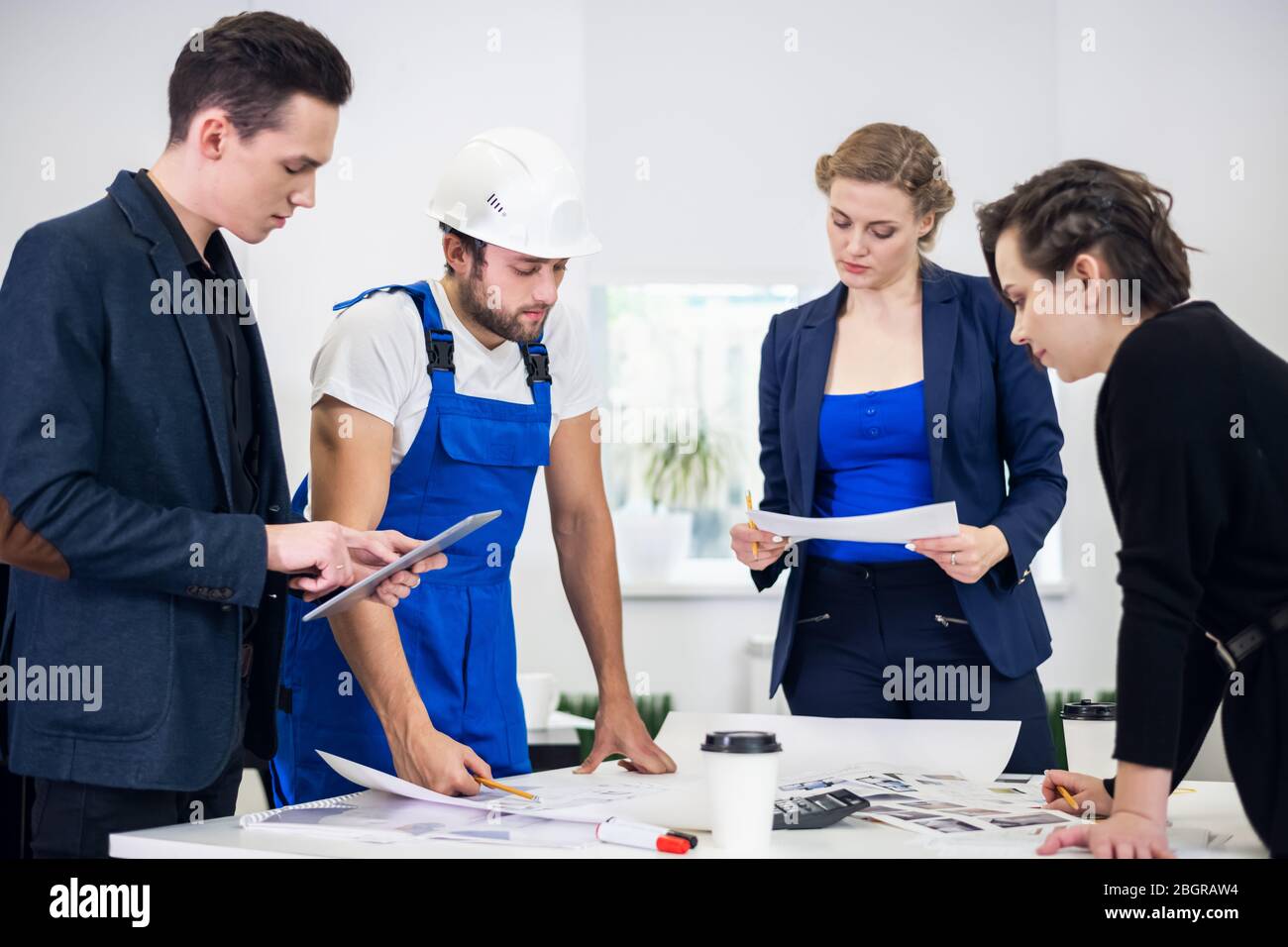 Team architects going over blueprints hi-res stock photography and ...