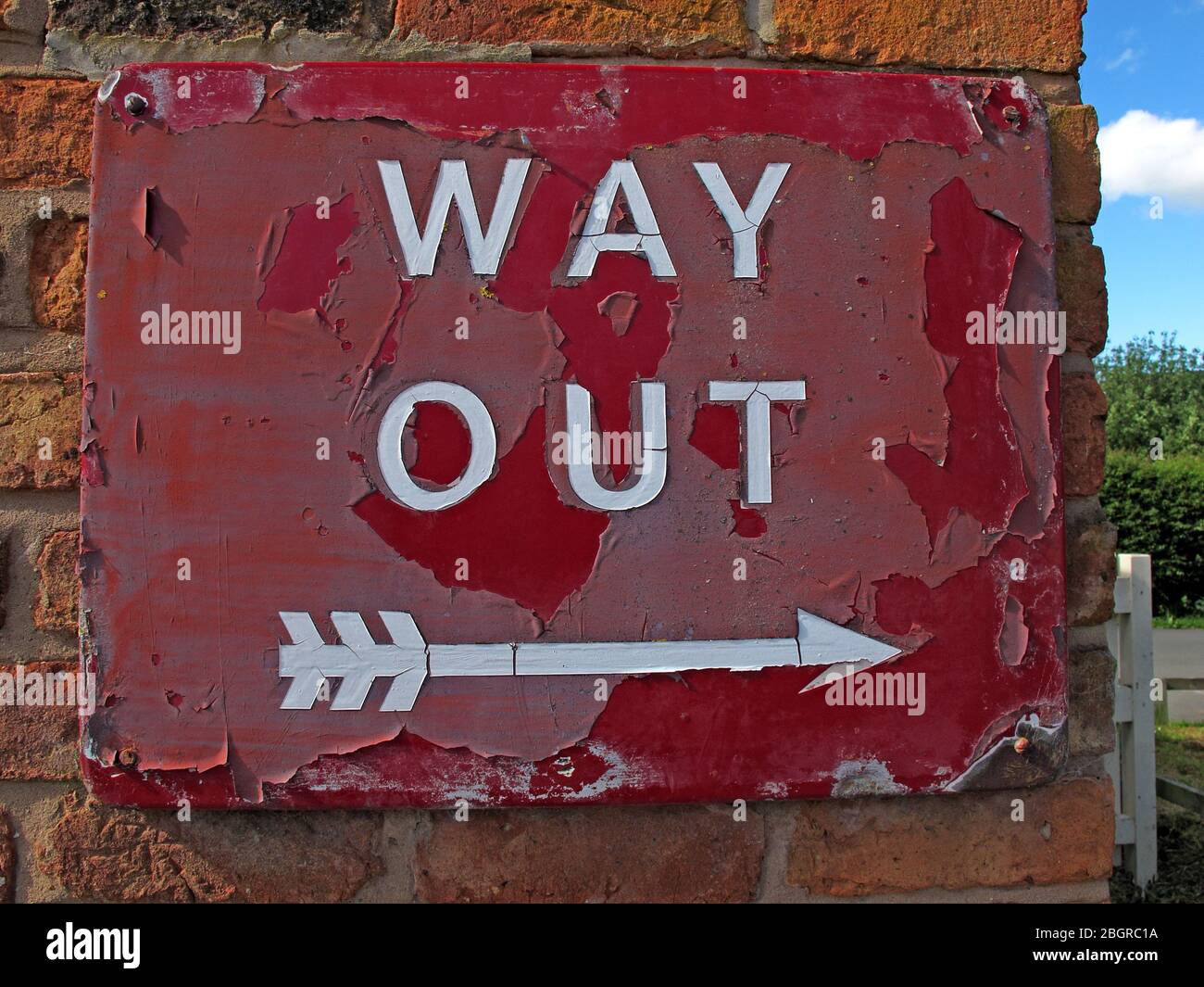Old British Rail, Way out sign, with arrow, worn history , historic signage Stock Photo