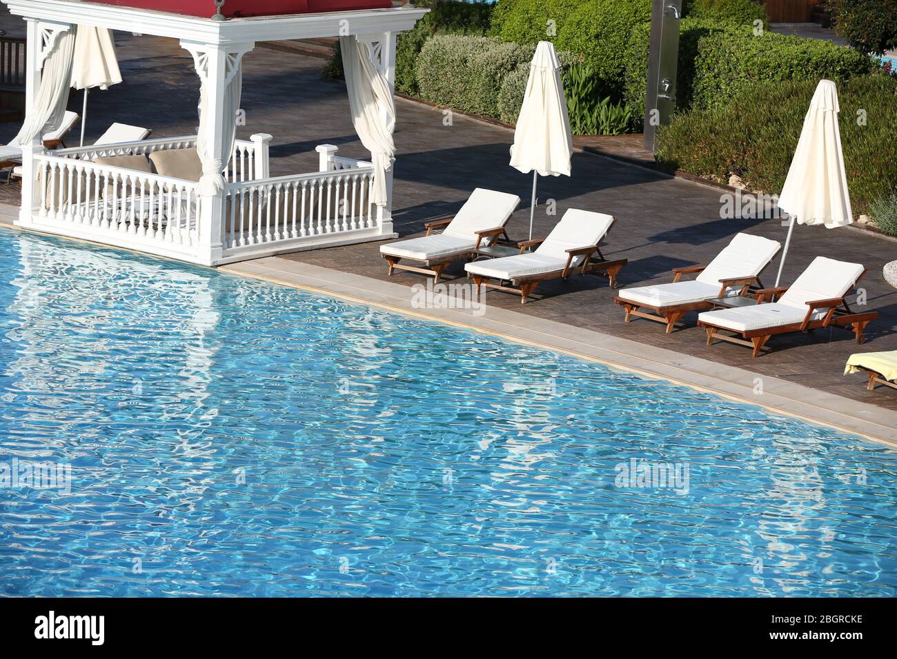 Lounge sunbeds near swimming pool Stock Photo Alamy